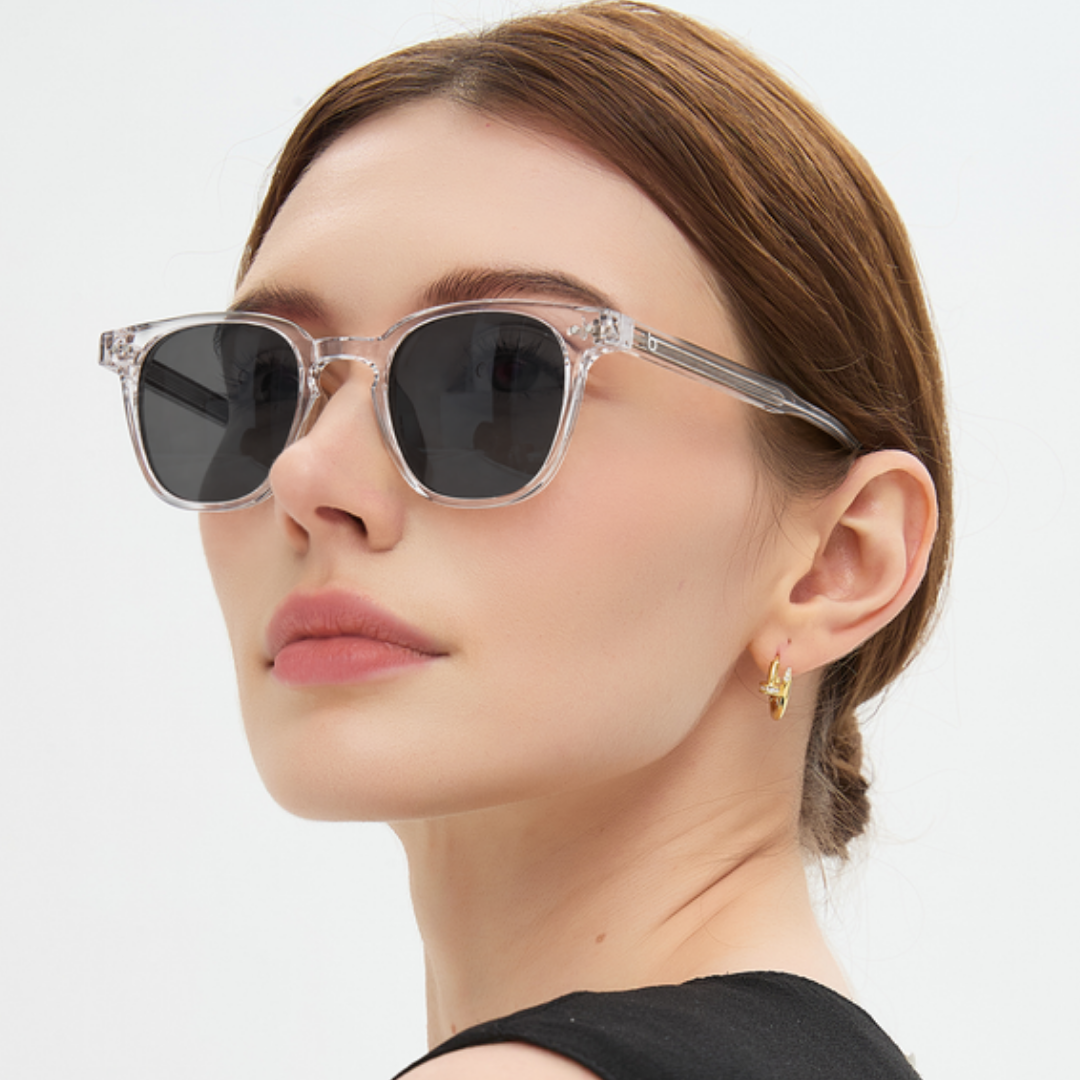 Portrait wearing Auguste Crystal sunglasses, dark grey lenses, transparent frame