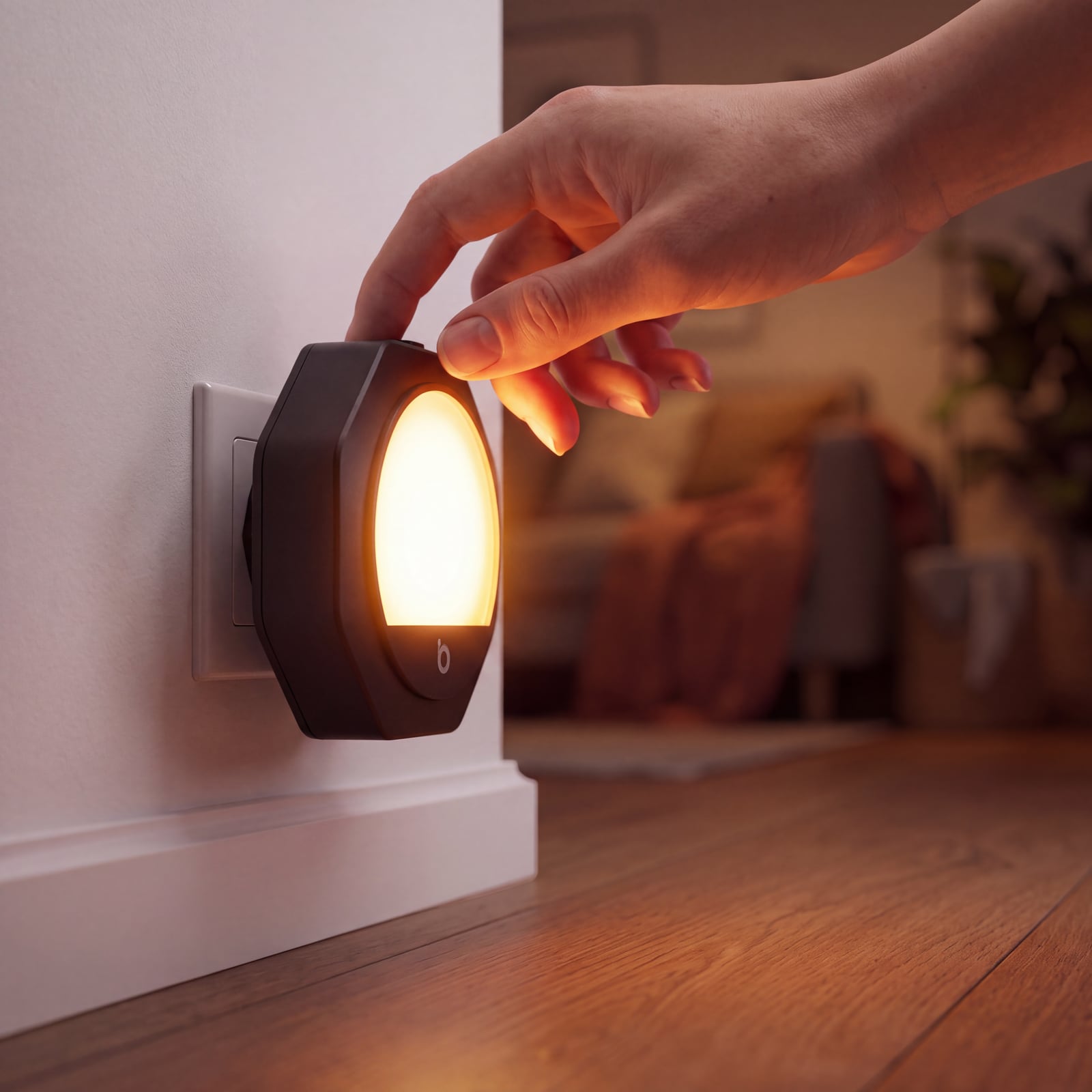 Hand touching the dimmer on an amber night light