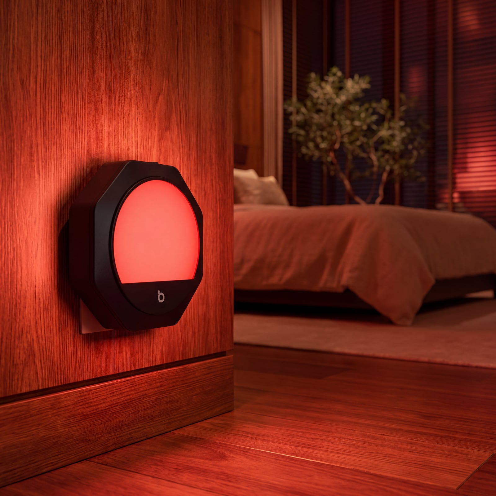 A red plug-in night light glowing on a bedroom wall